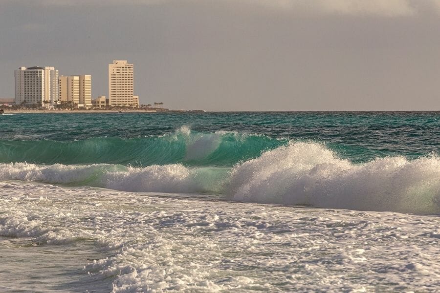 Cancun Beach with waves and hotels in the horizon