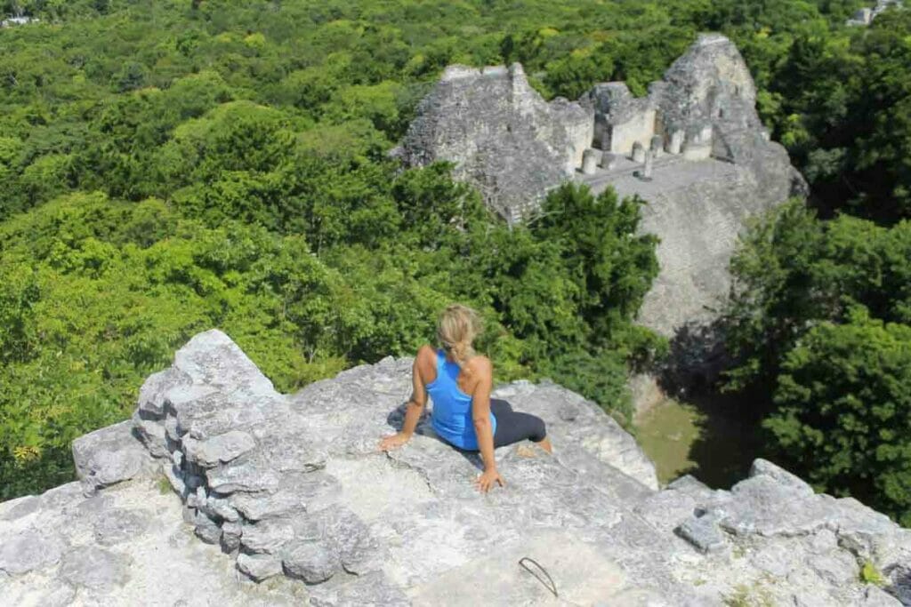 a girl sitting on a temple in Calakmul 