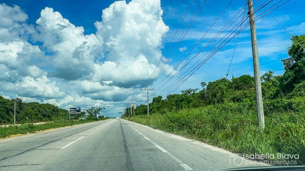 Open road with clouds and power lines