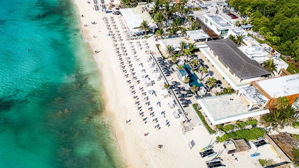 Aerial view of beach resort by turquoise ocean.