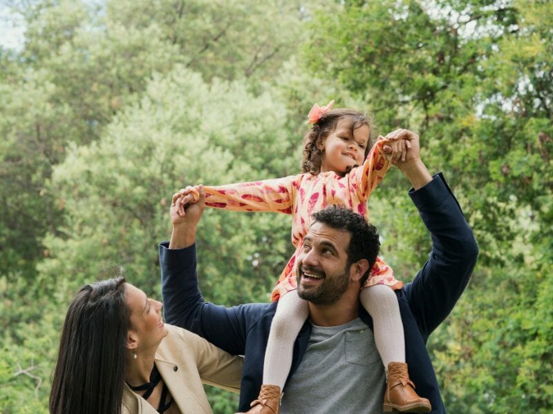A family of three enjoying their stay at the park