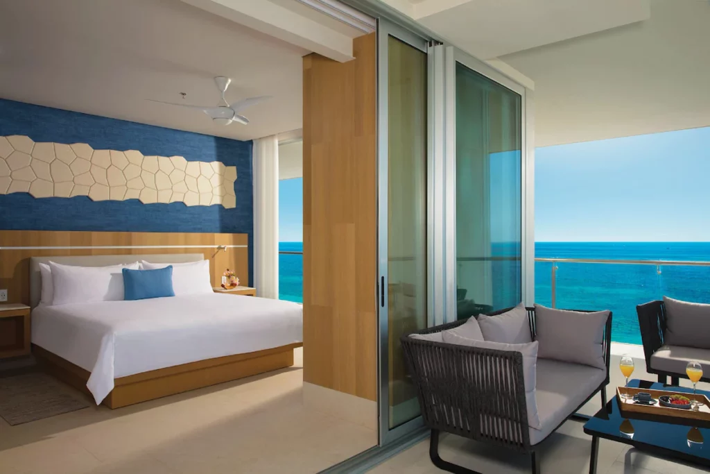 room with double bed and terrace overlooking the water at dreams vista cancun all inclusive resort