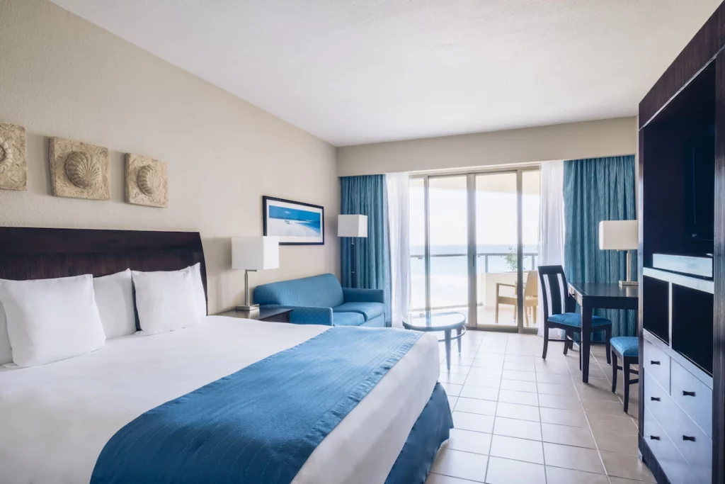 standard room with couch, table and chairs at Iberostar Cancun
