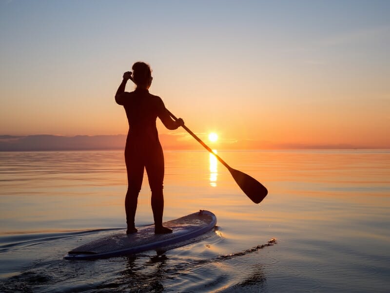 paddle boarding at sunset