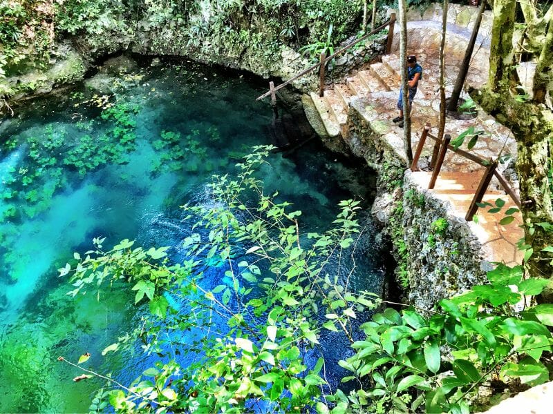 A beautiful cenote in Cancun with blue waters.