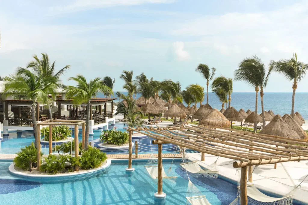 View of the pool area with huts under the blue sky