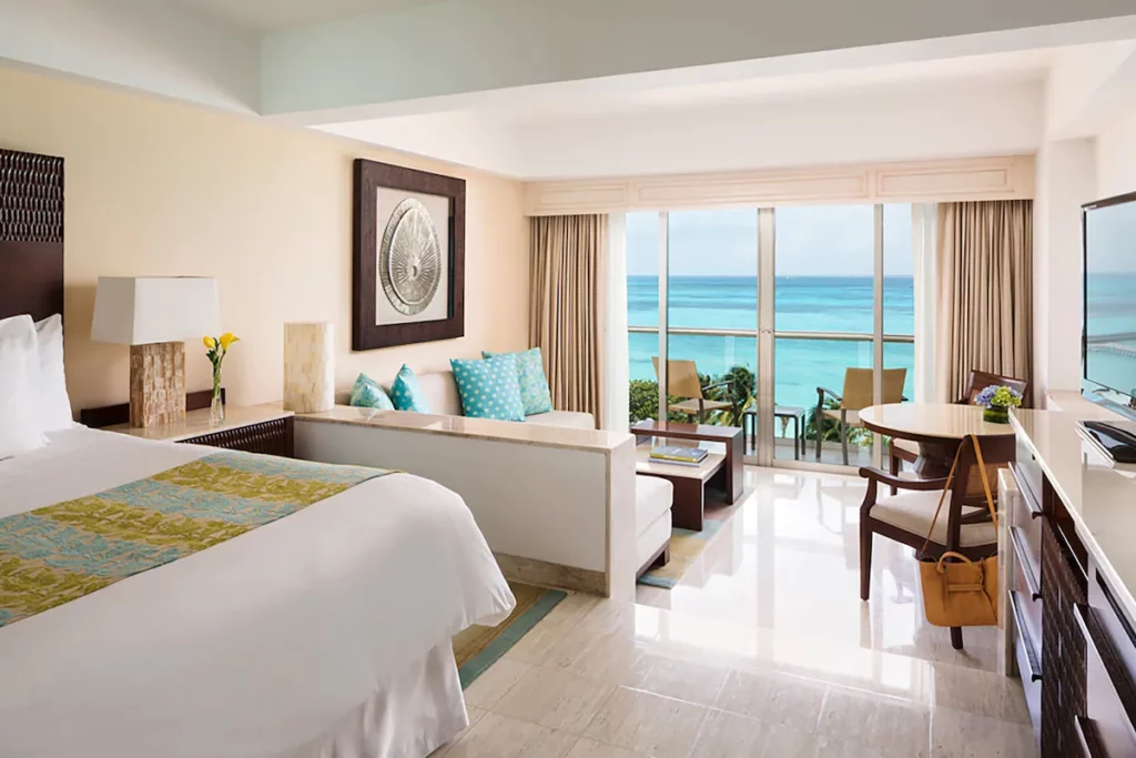 Luxury room with a small living room area with an amazing view of the beach