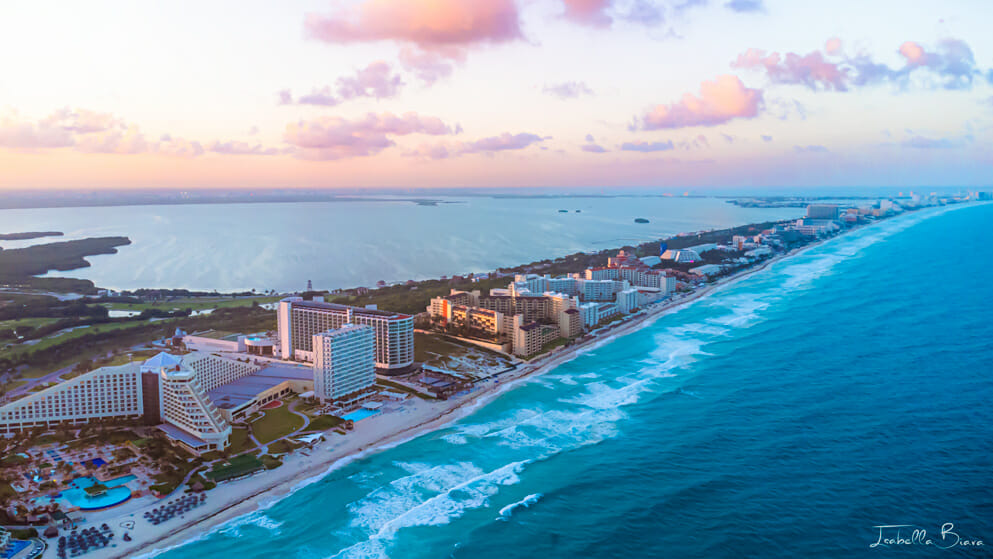 Aerial view of the Cancun Hotel Zone under a pink sky