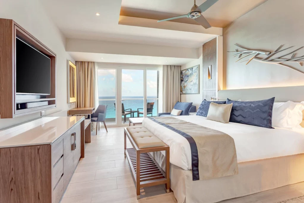 room with king bed and tv on the left side of the photo