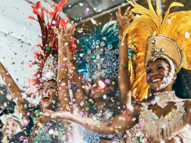 Three female samba dancers smiling