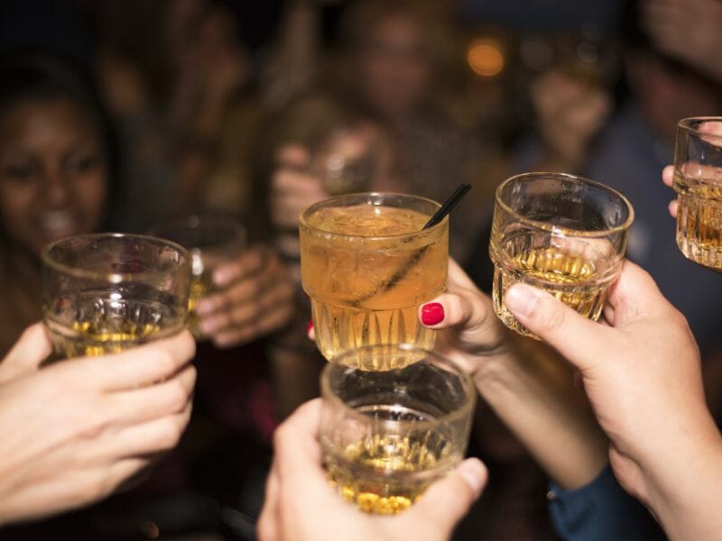 People raising their cocktail glasses