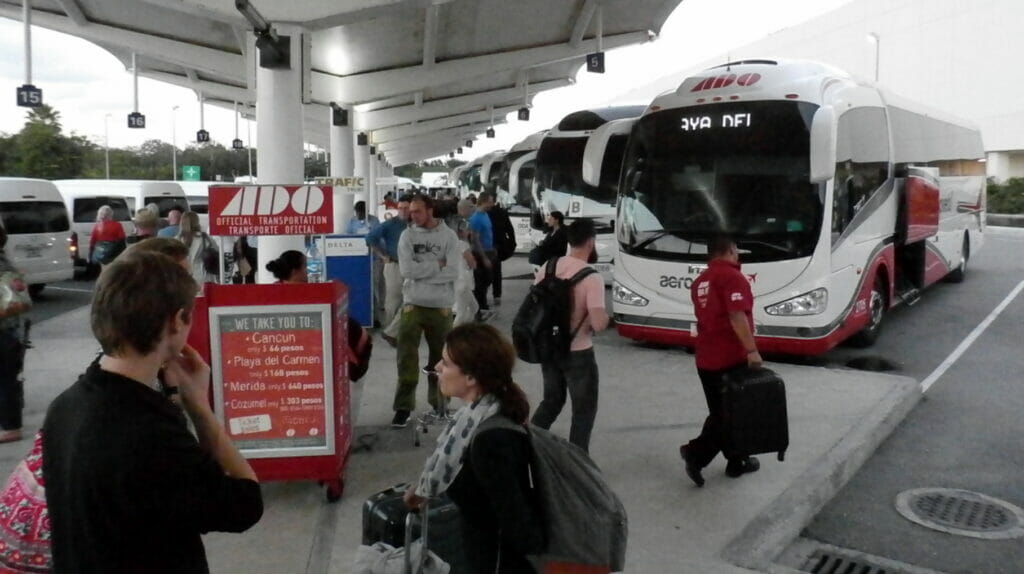 ADO Bus Terminal at Cancun Airport with people