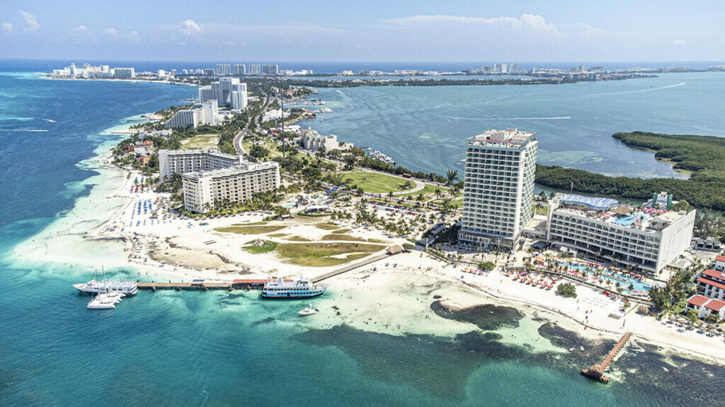 Aerial view of Cancun Hotel Zone surrounded by blue sea - tipping in Cancun.