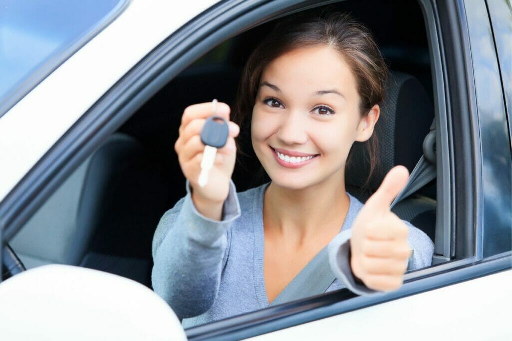 Happy Girl with car rental key in her hand - For sure she has avoided Cancun car rental scams. :)