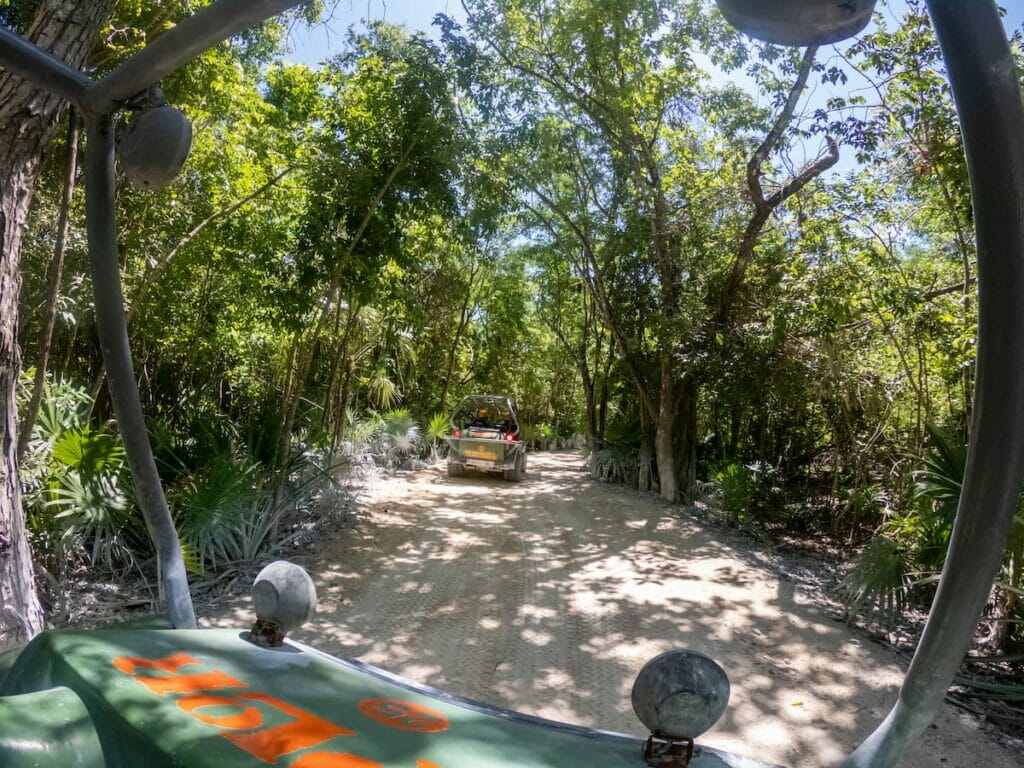 A narrow road in Cancun with ATVs.