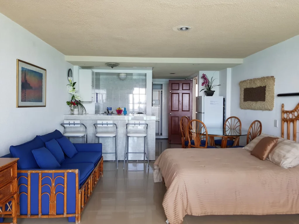 Salvia Cancun Aparts with bed and sofa.