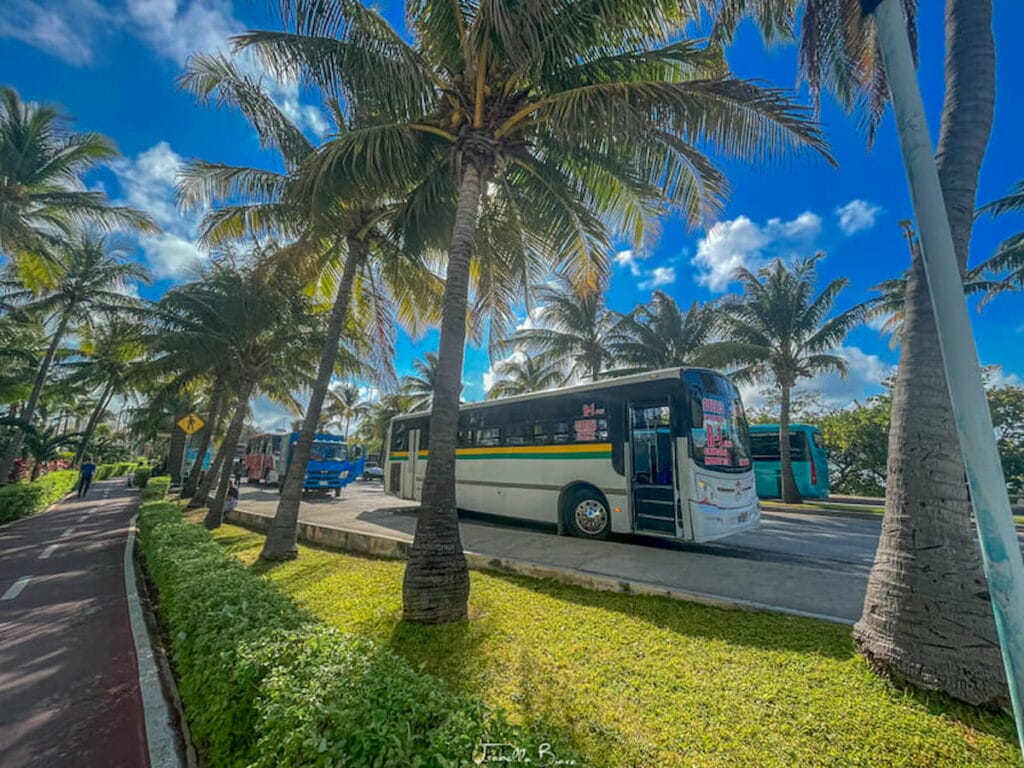 Bus on a busy road in Cancun Hotel Zone - tipping in Cancun.