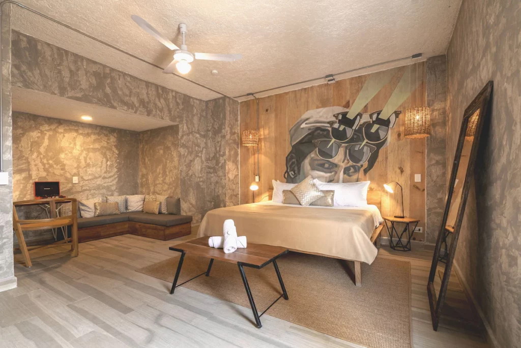 Modern style room in Selina Cancun Downtown with an art mural on the wall.