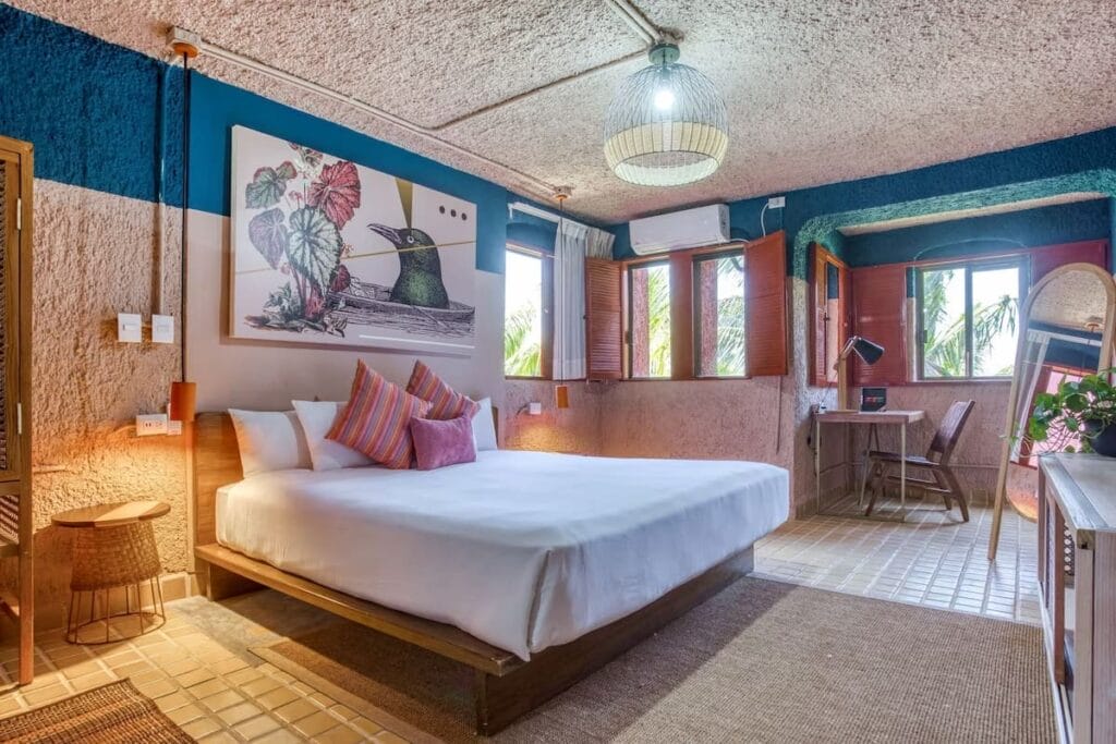 Selina Cancun Laguna Hotel with spacious room and cozy bed.