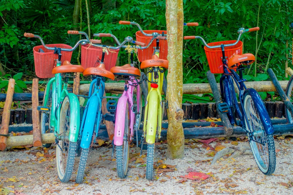 Colorful Bikes parked by a park in Tulum