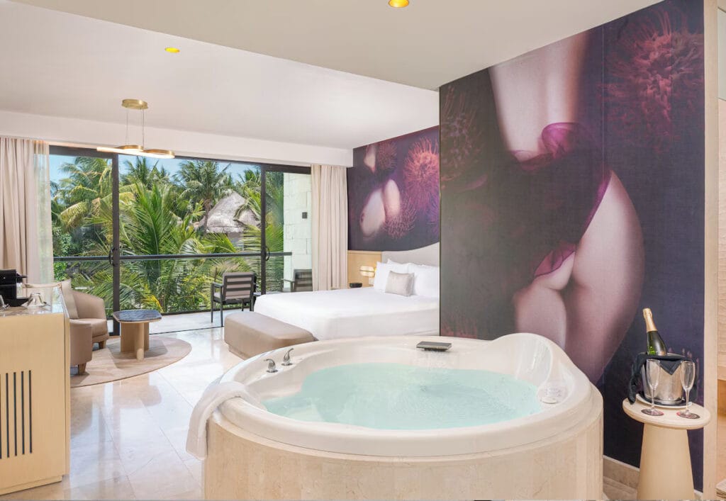 Luxury hotel room with jacuzzi and balcony view.