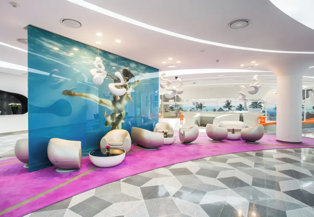 Modern hotel lobby with abstract underwater art.